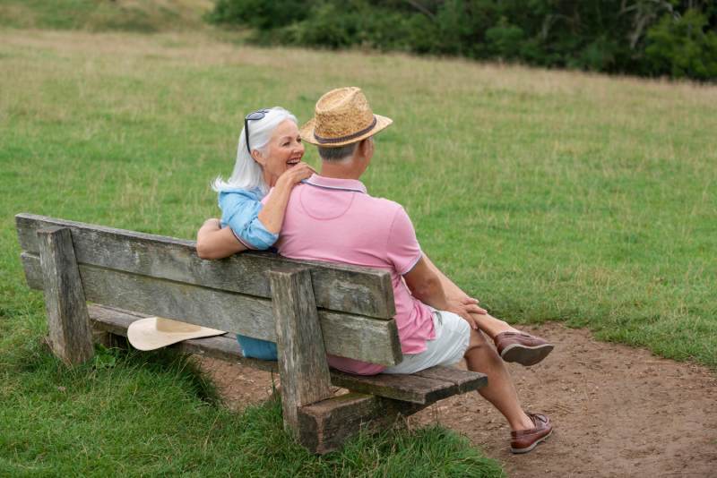 Adorable senior couple sitting on a bench